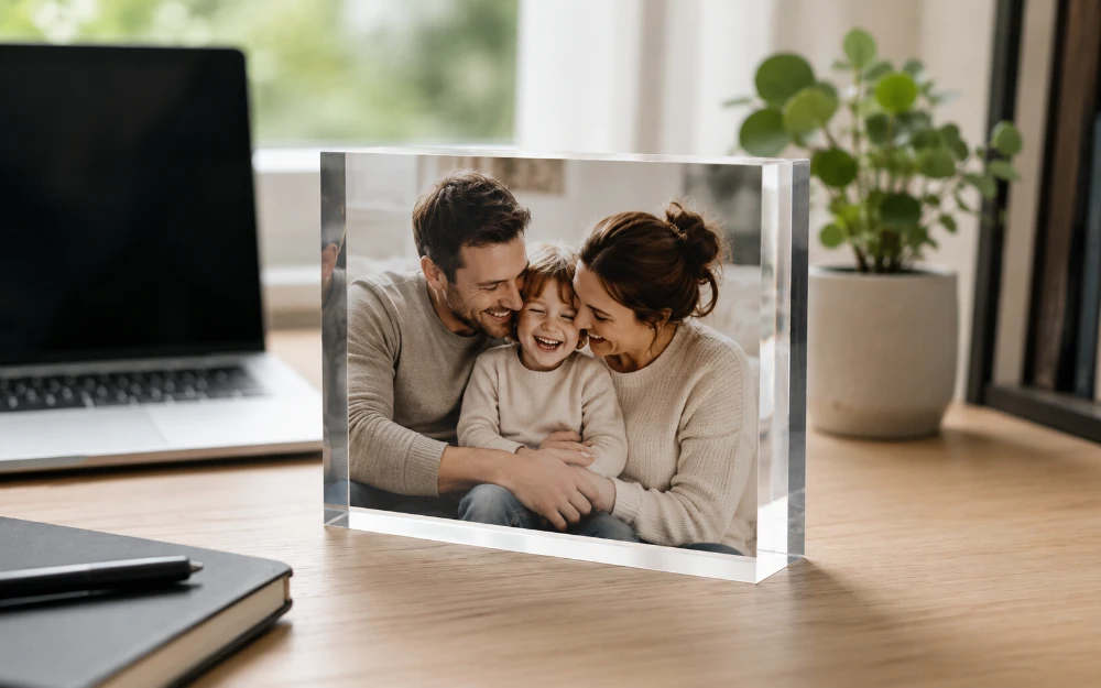 Close-up of a thick 2.5cm acrylic photo block standing upright on a desk, light glowing through its edges to give the photo a 3D depth effect