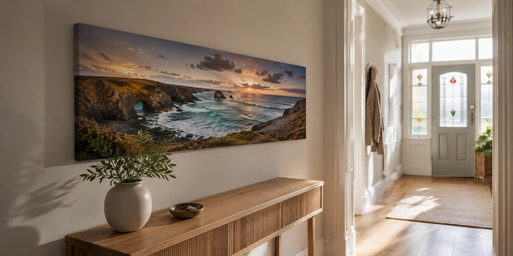A panoramic canvas print of a wide landscape hung above a sideboard