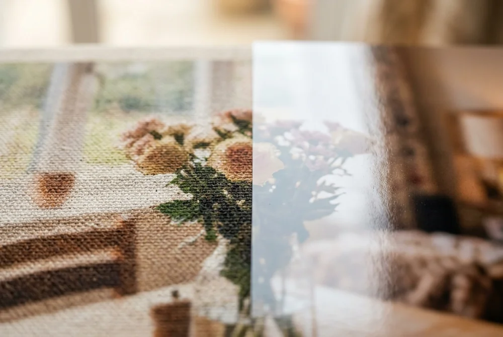 Close-up comparing a photo printed on canvas weave against a smooth glossy print