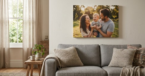 Canvas prints of family and landscape photos leaning against a white wall in a UK living room