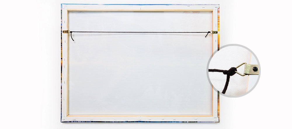 How to hang your canvas print. The complete guide. Cord through the triangular D-rings.