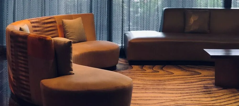 Wall Art Trends. Two large sofas in curtained room.