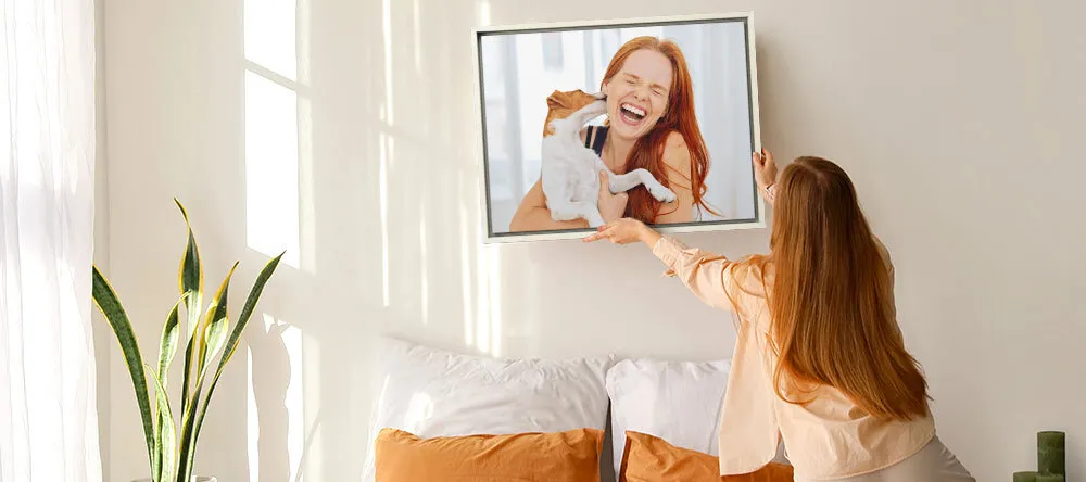 What is a Shadowbox Frame. Woman hanging canvas print in floating frame.
