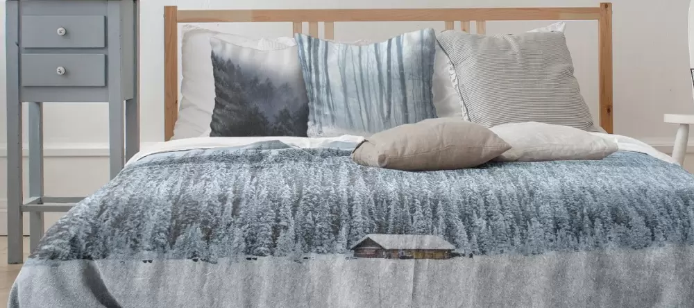 Photo gifts for her. Personalised photo blanket and photo cushion on bed.