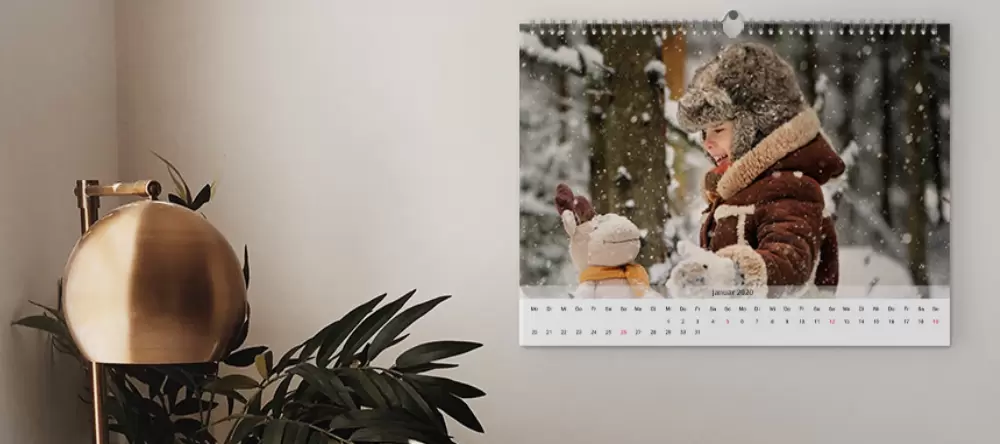 Photo gifts for her. Personalised photo calendar on wall.