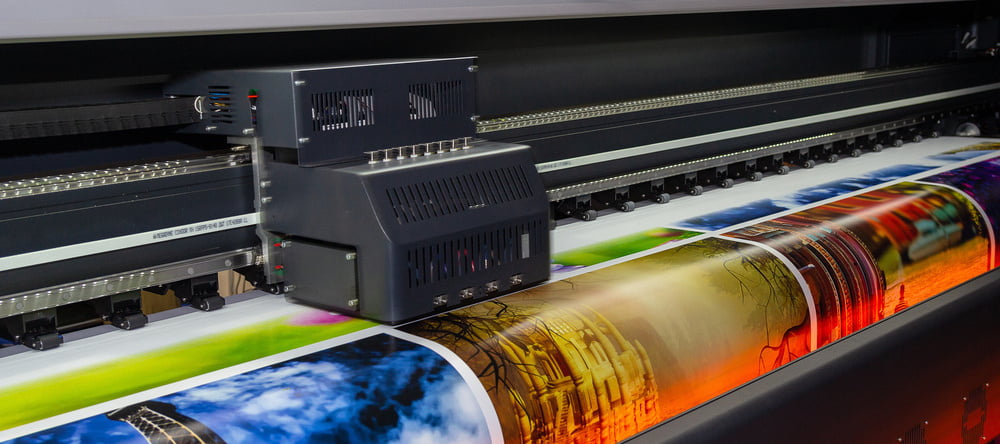 What is a Giclee Print? Printing machine printing photographic images.