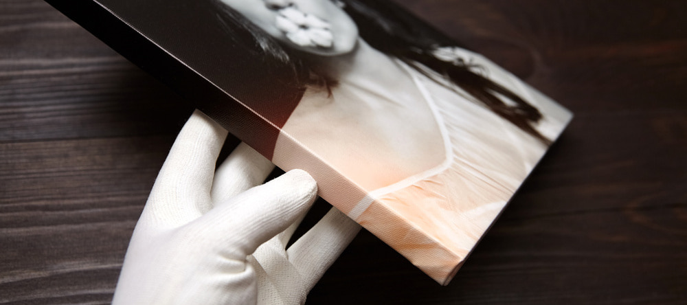What is a Giclee Print? Gloved hand holding print on frame.