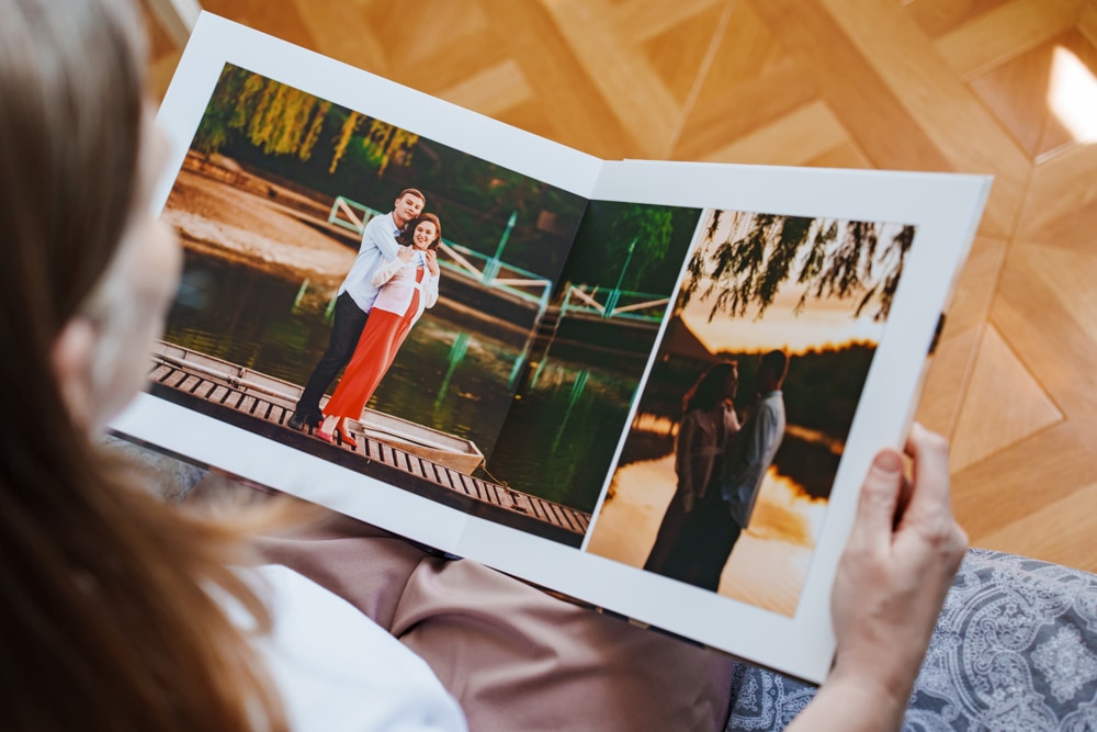 Couple creating a shared memory display with photo prints and keepsakes