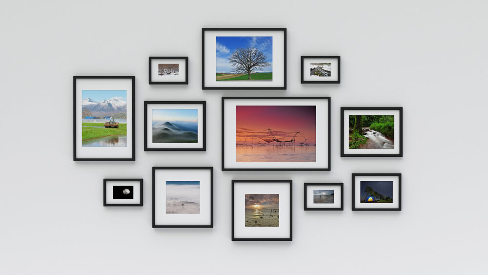 Various styles of wall art and canvas prints decorating a living room, useful for new homeowners
