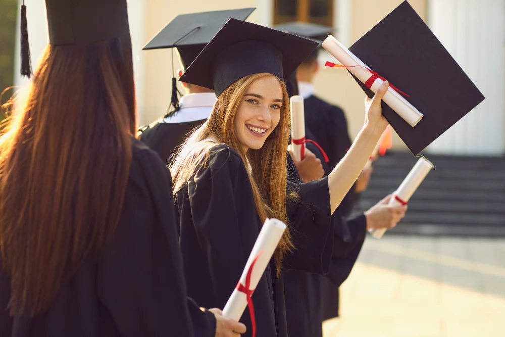 A student receiving a diploma during a graduation ceremony, with a subtle overlay of a motivational quote about new beginnings