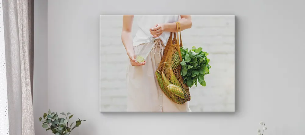 What is Lamination on Canvas Prints. Print on wall showing woman holding vegetables.