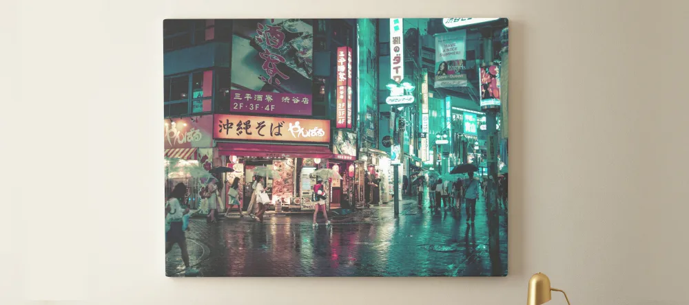 What is lamination on canvas prints. Print on wall showing urban nighttime scene.