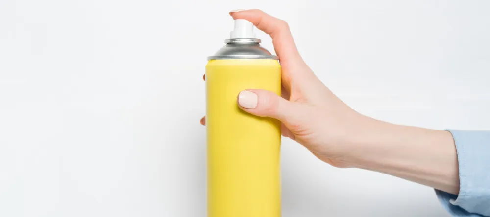What is Lamination on Canvas Prints. Hand pressing spray can nozzle.