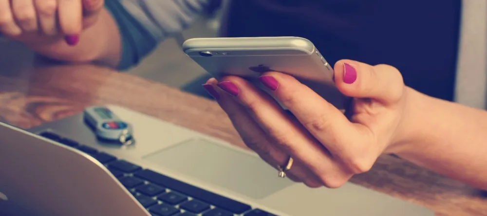 Should I Buy Canvas Prints from My-Picture.co.uk. Woman holding cell phone.