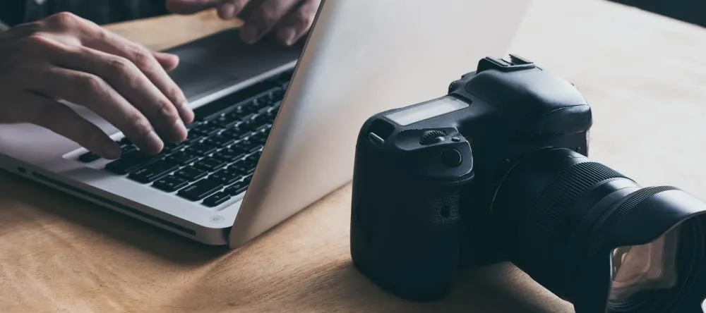 What is the Best Resolution for Canvas Prints? Close up of photographer checking images on laptop.