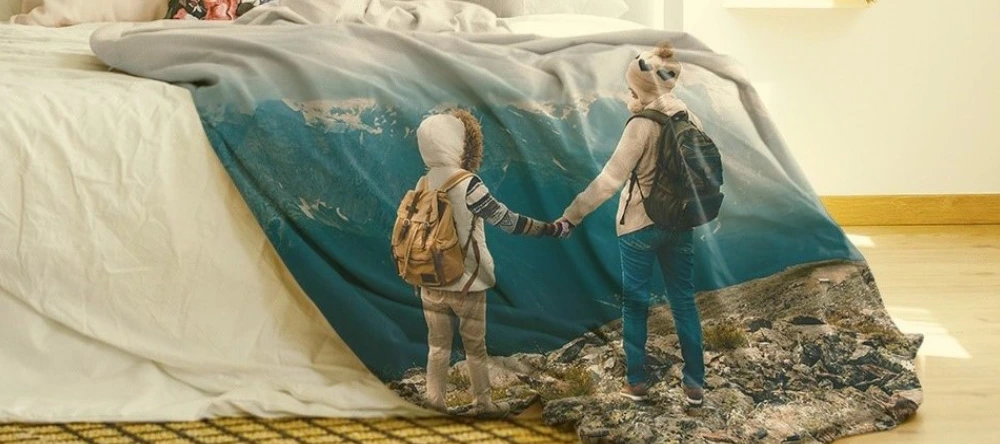 Latest lifestyle trend. Personalised photo blanket with two kids and a mountain terrain. 