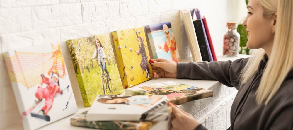 Where to Print Pictures Near Me. Young woman being happy about her canvas prints.