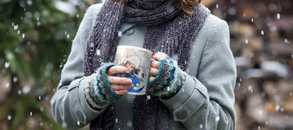 Personalised Christmas Mugs UK: Our 4- Step Guide. Woman holding a personalised photo mug.