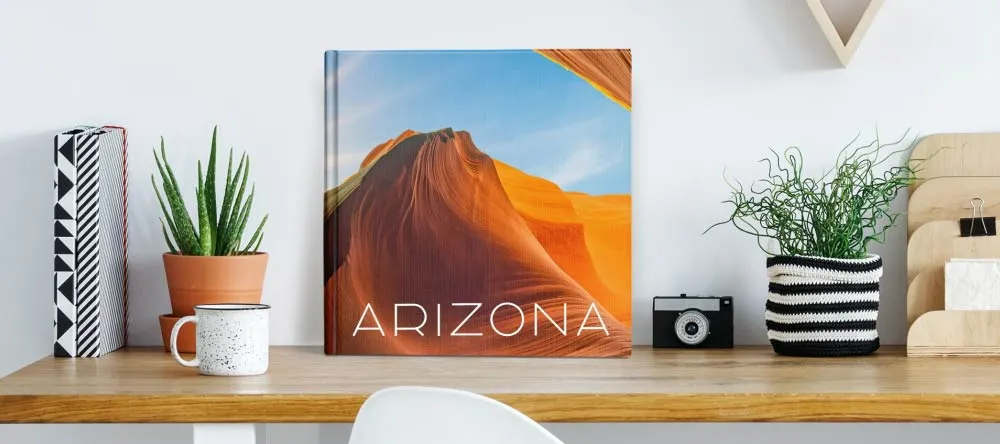 How to Make a Photobook. Personalised photobook on work desk. 