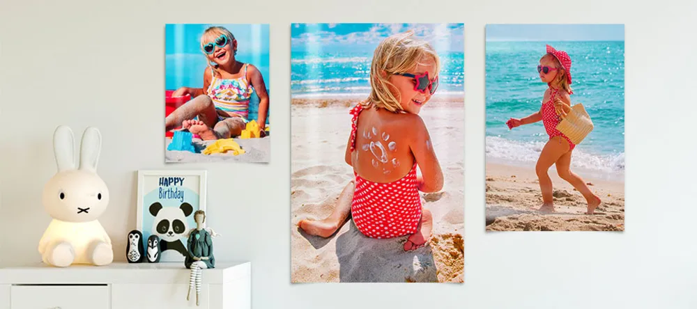How to Hang Posters without Damaging the Wall. Photo posters on wall showing pictures of girl.