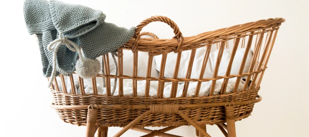 What do you take to a baby shower. A child's cot with a knitted garment.