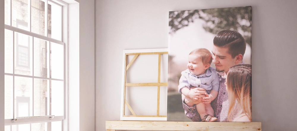 What do you take to a baby shower. Printed photo of family next to window.