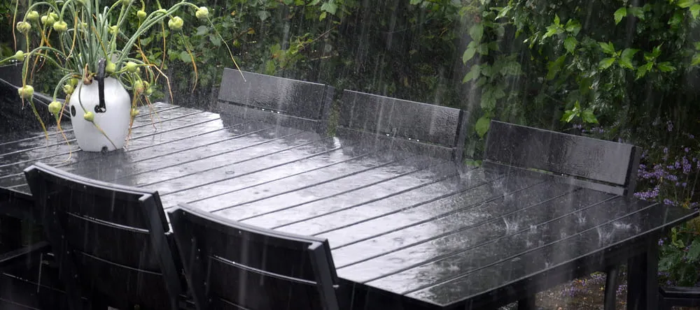 Outdoor Canvas Art. Rain falling on table in garden.