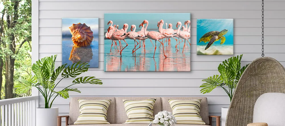 Outdoor Canvas Art. Three canvas prints on wall outside.