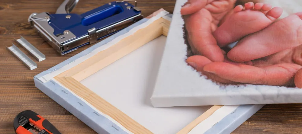 What is a Rolled Canvas Print? Two canvas prints wrapped on frames next to staple gun.
