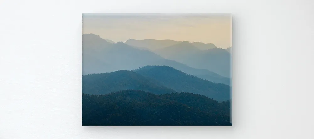 What is a Rolled Canvas Print? Canvas print on wall showing mountain range.