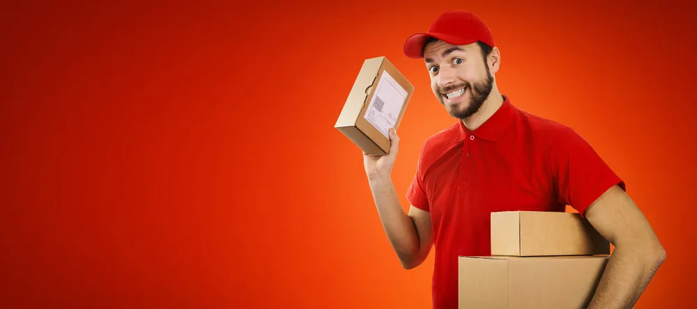Photobook Fast Delivery UK. Delivery man holding parcels.