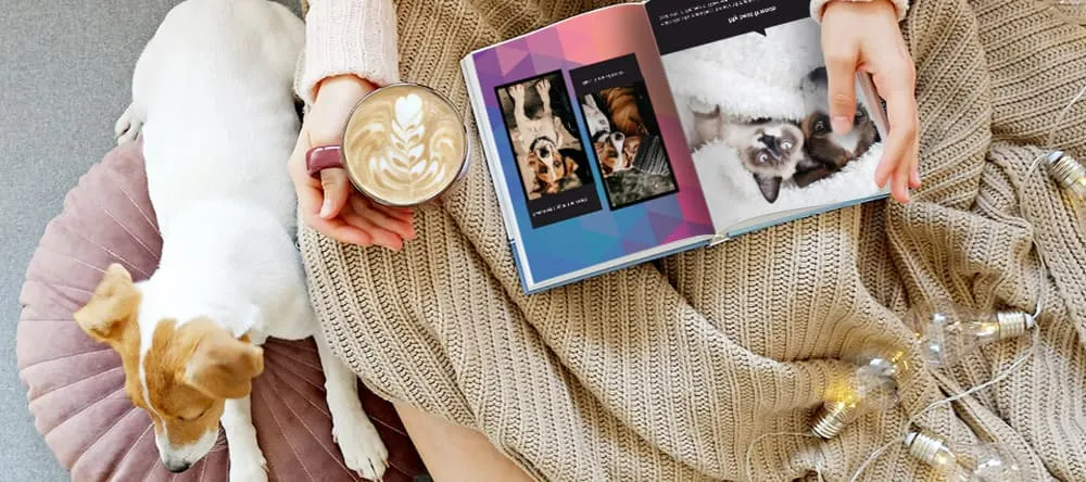 Photo Album Ideas. Woman looking at photo image alongside dog.