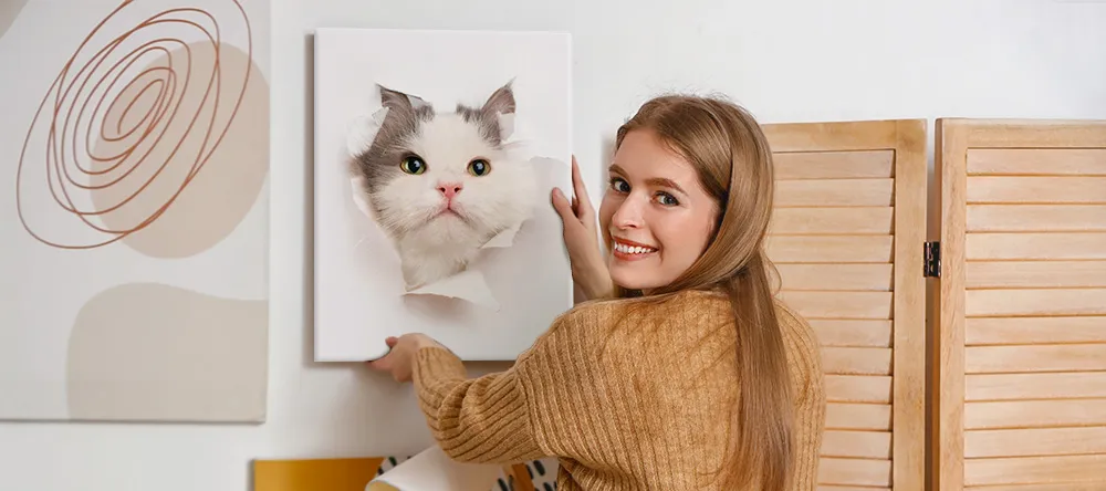 Cat Canvas Art: Our Favourite Felines on Canvas. Young lady setting up her canvas wall art featuring a photo of her cat.