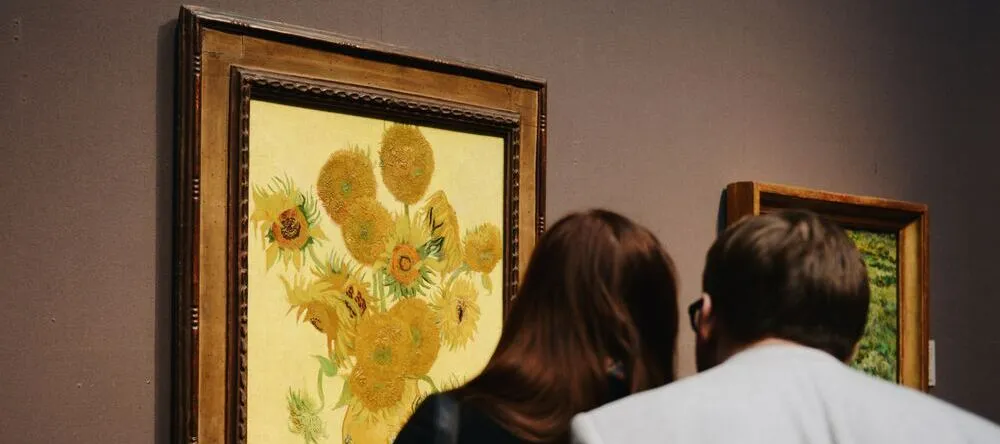 What is a Floating Frame for Canvas. Couple looking at framed paintings on wall.