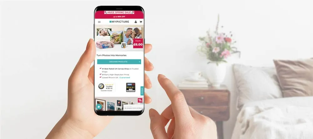 How to arrange photos on a wall: a person browsing MYPICTURE via smartphone