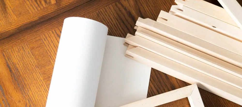 How to stretch a canvas: a rolled canvas and stretcher frames on the table