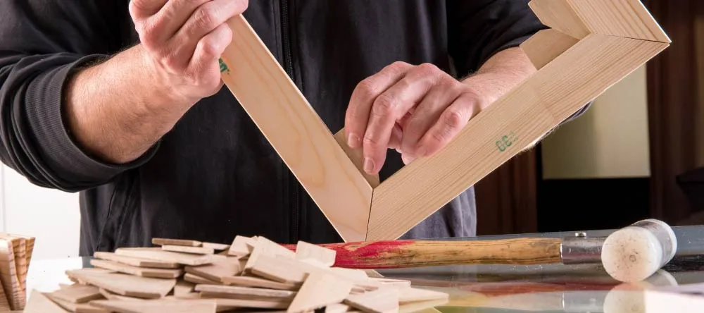 How to stretch a canvas: a person stretching a canvas print over the frame