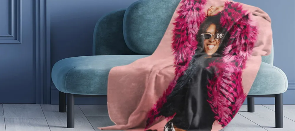 What is a Throw Blanket. Sofa with blanket featuring print of woman.