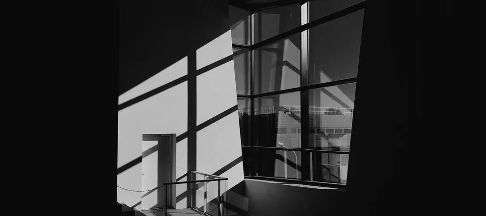 Black and White Canvas Wall Art. Modernist building with light coming through window.