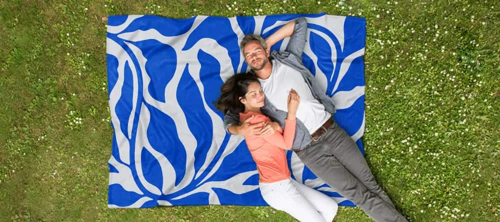 Personalised picnic blanket: a couple lying on the printed blanket