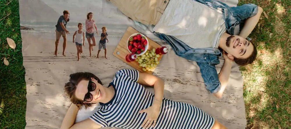 Personalised picnic blanket: a couple enjoying snacks on a picnic