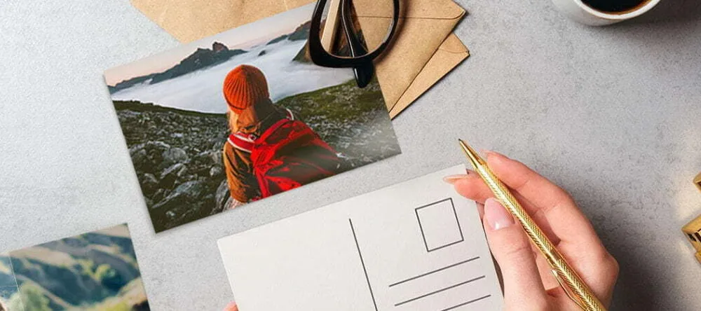 What size is a postcard UK: a person signing a postcard