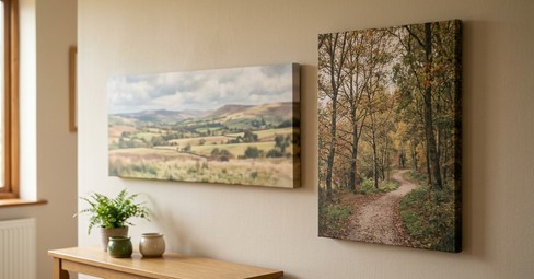 Panoramic canvas print of a coastal beach scene hanging above a grey sofa