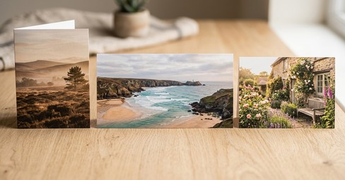 Folded, panorama and postcard photo cards arranged on a wooden table