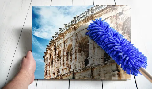 Cleaning canvas with a feather duster