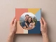 hardcover photo book gallery square cover held in hands thumbnail