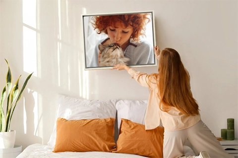 hanged framed canvas with a portrait of a kid and a cat